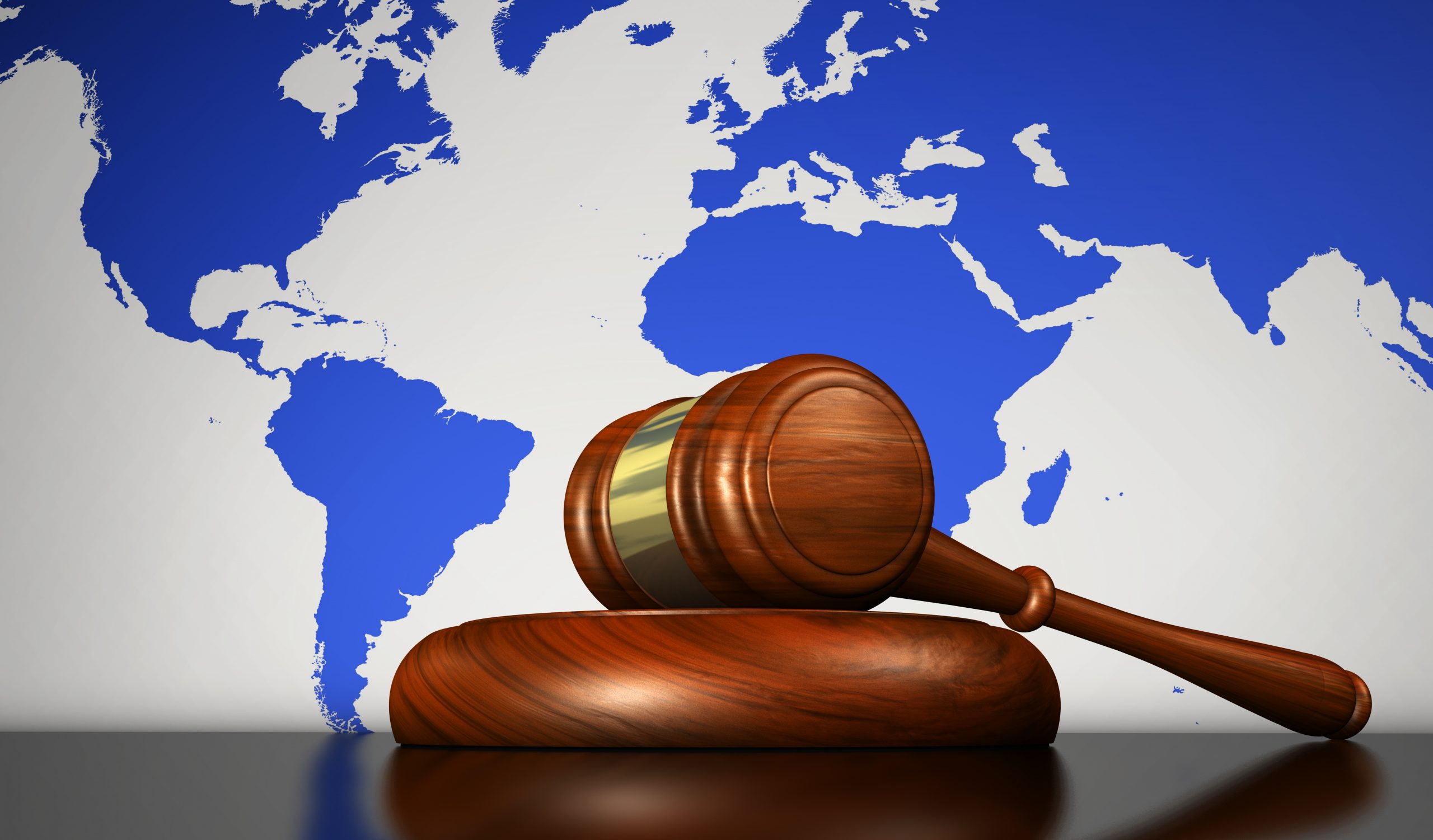 International law, justice, human rights and global business concept with a gavel and the world map on background 3D illustration.